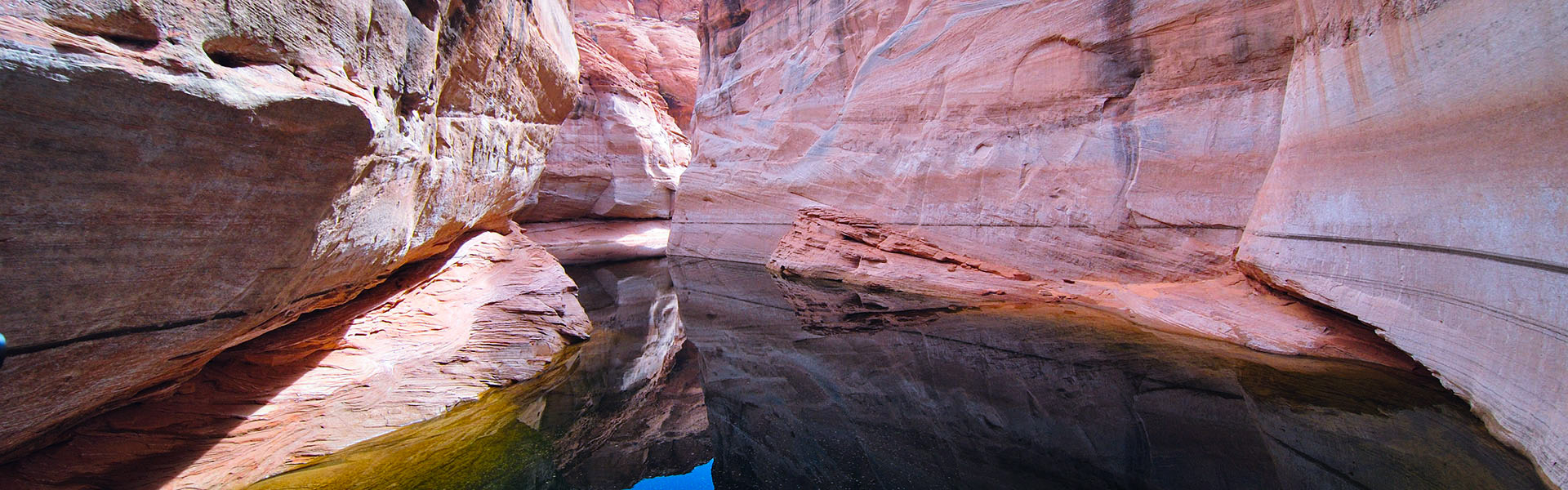 Sandstone walls reflected in the waters of Antelope Canyon